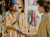 Smiling Man Making Payment in Clothing Store