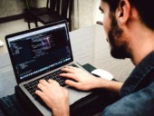 Man encoding on a laptop.