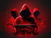 Faceless hackers in red shadows using laptops, along with abstract digital symbols.