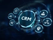 CRM sign with related integrations on a blurred digitial background.