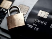 Close up image of a padlock on top of credit cards.